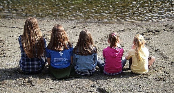 Children sitting on beach and homeschool