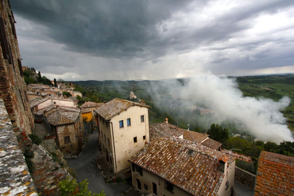 A spring storm meets smoke from burning olive branches in Montalcino