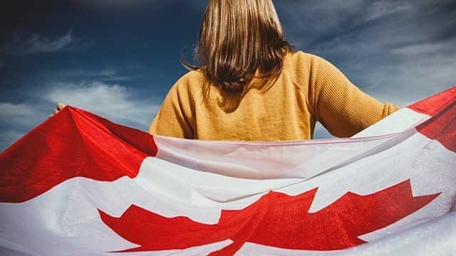 holding-canadian-flag-697 • Troy Media The adoption in Canada of the Maple Leaf flag over the Red Ensign was a full-blown fight over identity, history, and politics