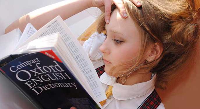 Girl reading dictionary memorization