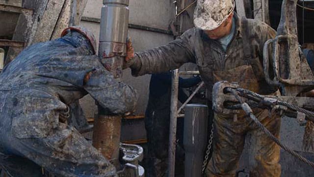 Oil-rig-workers Forecast calls for a strong recovery in crude oil demand