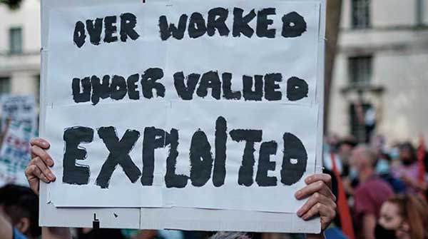 protesting-worker-exploitation sign wage