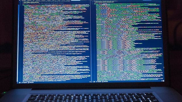 Laptop-Computer-Turned-on-Showing-Computer-Codes • Troy Media