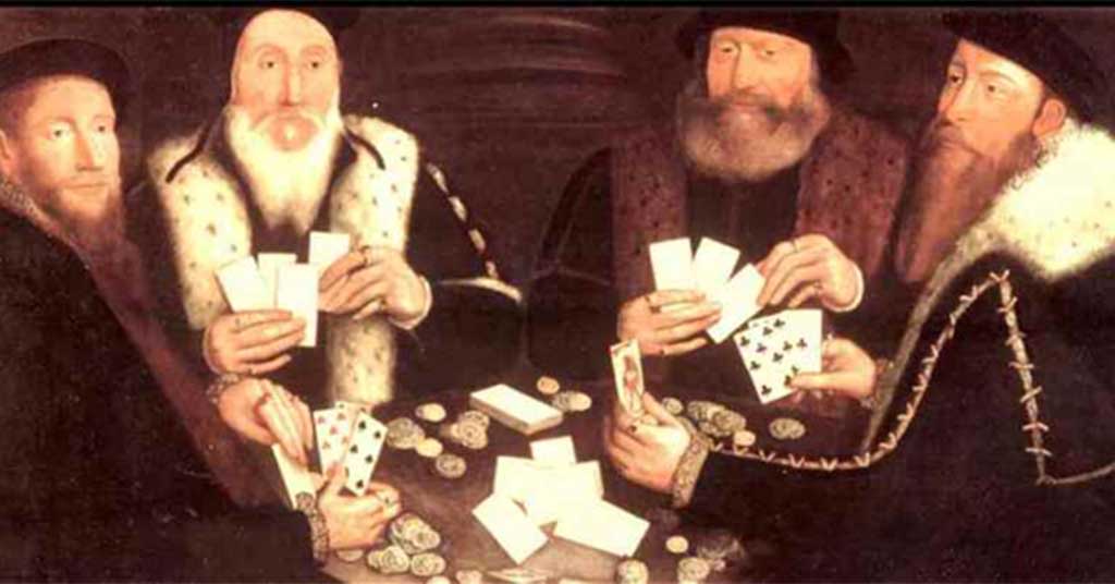 Poker • Troy Media Four men wearing period clothing sit around a table playing cards, with poker chips and scattered cards on the surface.