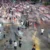 Crowded city crosswalk with motion-blurred pedestrians moving in all directions at a busy intersection.**)