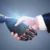 Handshake between a person in a suit and a robotic prosthetic hand, symbolizing human–robot collaboration.