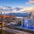 Wide view of an energy complex at sunset featuring a white modular reactor building labeled 'MMR' and a Canadian flag.