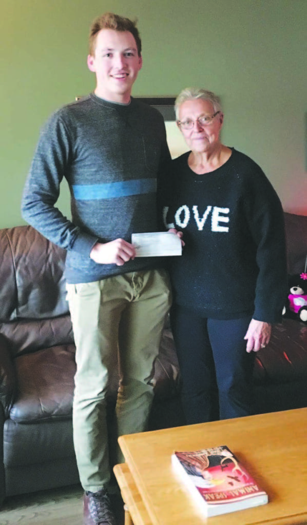 Vivian Kalmer, administrator for the Kindersley & District Health & Wellness Foundation, presents the $1,000 Brian Martin Bursary to Sheldon Cannon, who is a third-year Bachelor of Science in physiology honours student at the University of Alberta