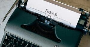 Vintage typewriter with a sheet of paper titled 'News' ready to be typed on.